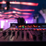 Sound mixer. Professional audio mixing console with lights, buttons, faders and sliders.